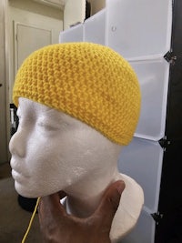 a mannequin wearing a yellow knitted hat